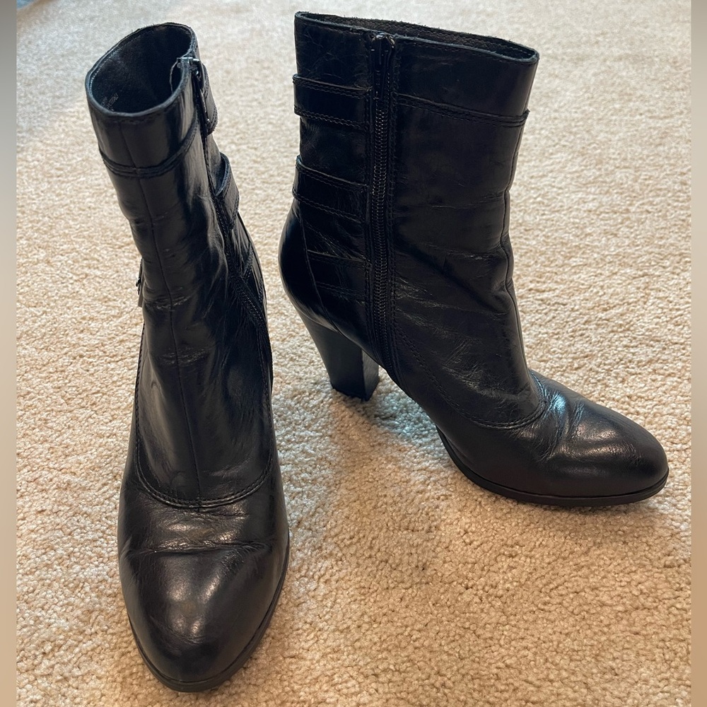 Born black leather boots with stylish buckle accents and side zippers.